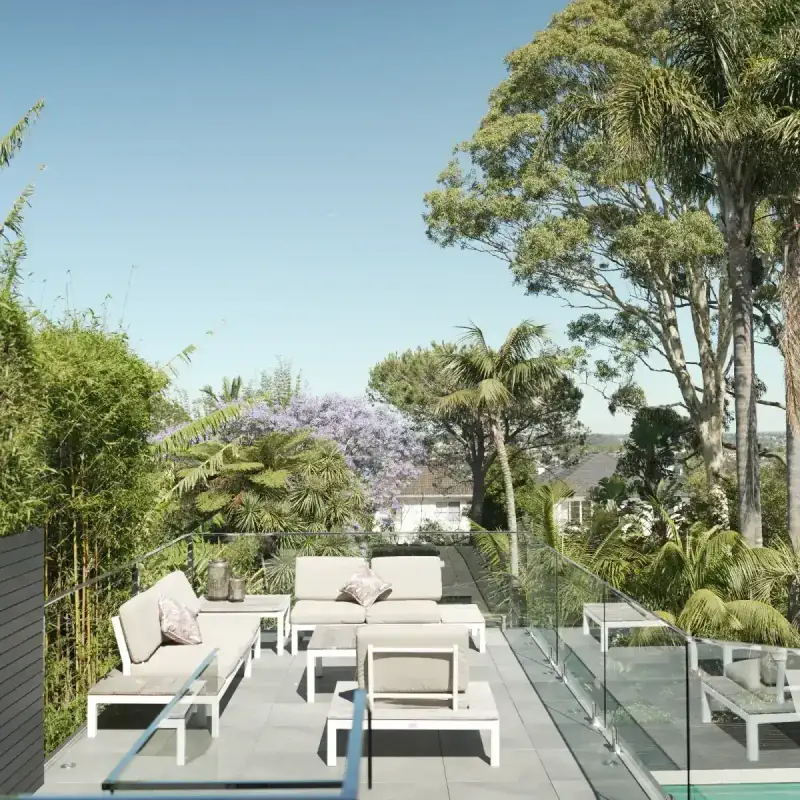 Outdoor balcony with white lounge furniture, glass balustrade and harbour views in Balgowlah