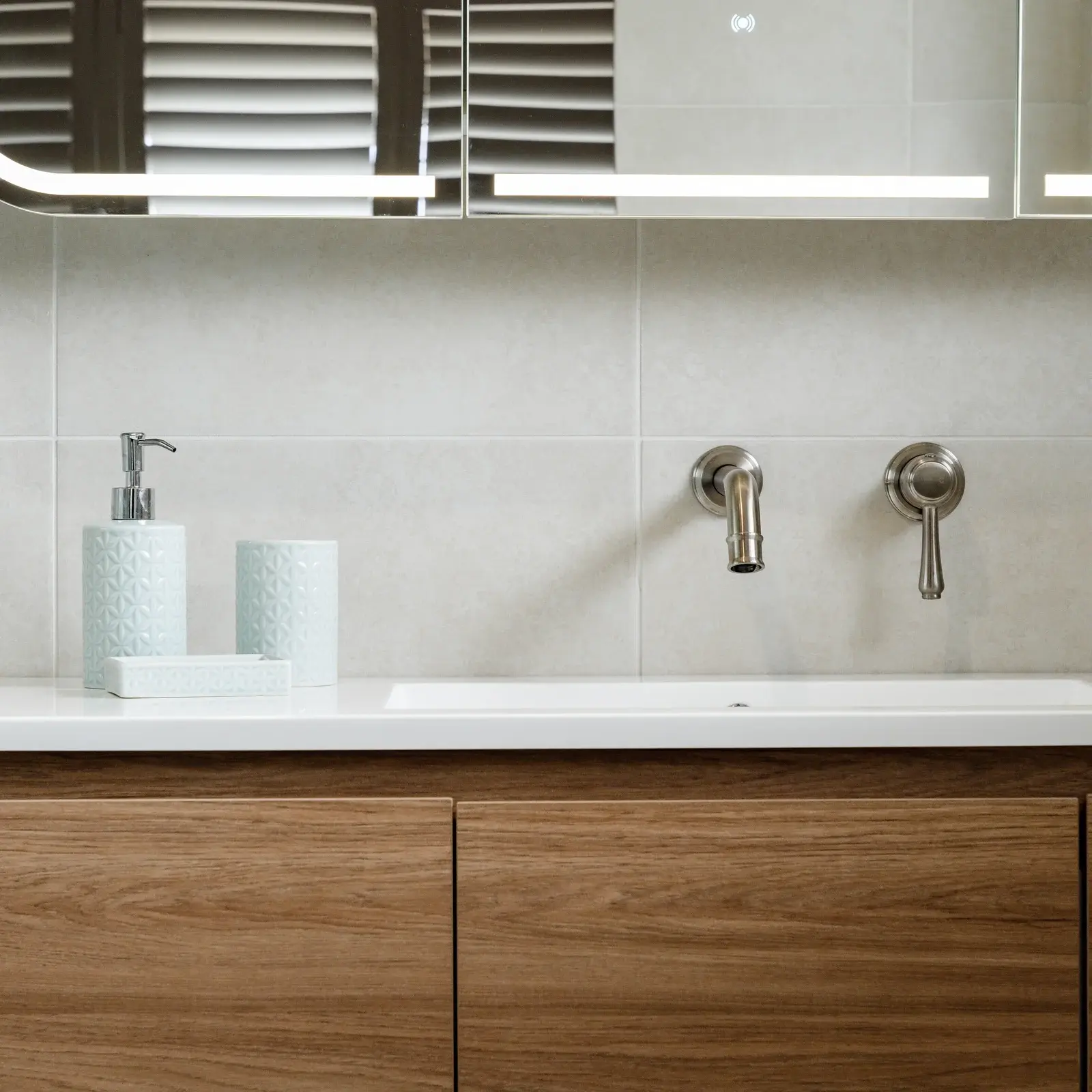 Modern Sydney bathroom with white tiles, chrome fixtures, and frameless glass shower screen
