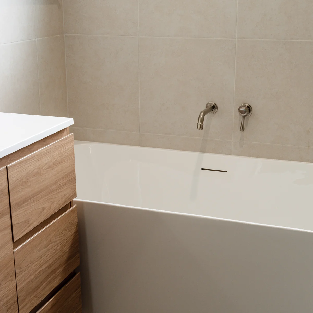 Freestanding bathtub with timber vanity in a luxury bathroom renovation