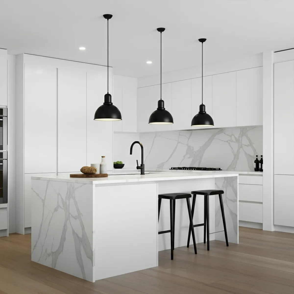White marble kitchen with black pendant lights, island seating, and integrated appliances