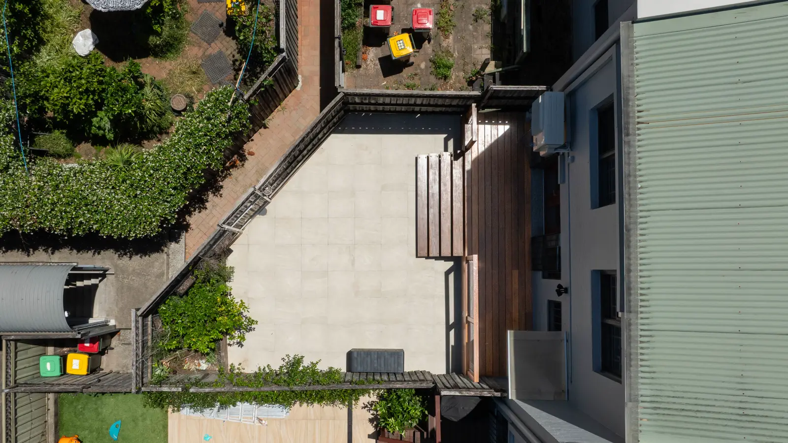 Aerial view of completed Alexandria renovation showing new deck, pavers and backyard