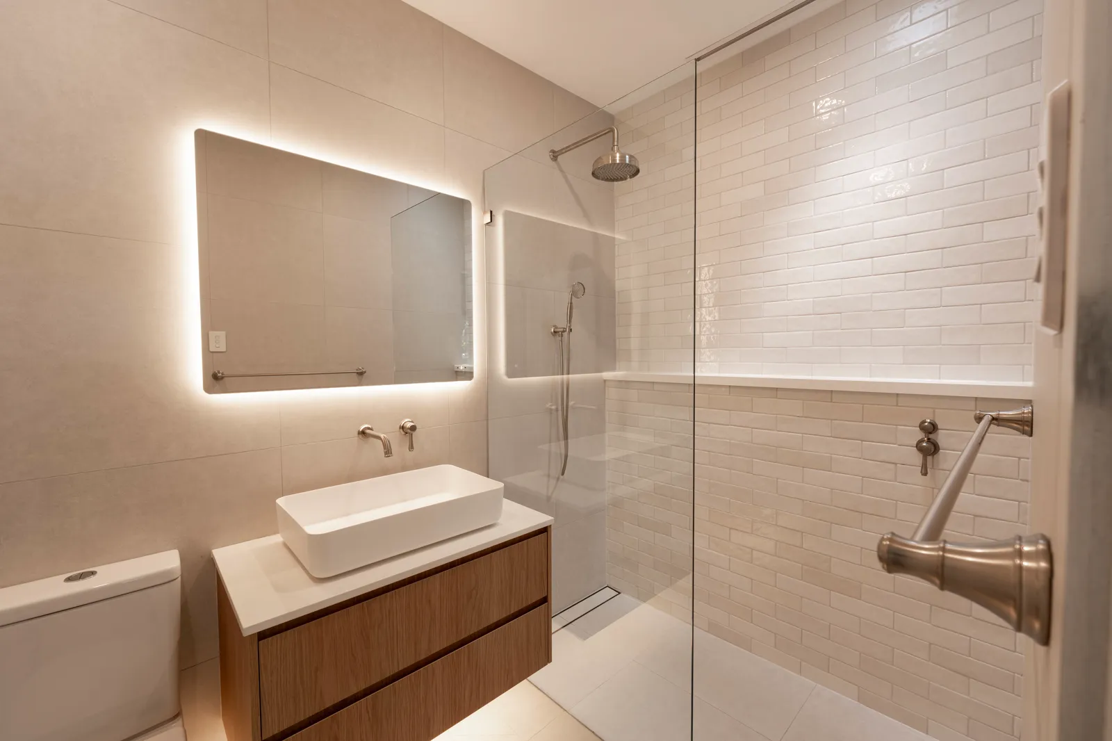 New ensuite with frameless glass shower, subway tiles and brushed nickel tapware
