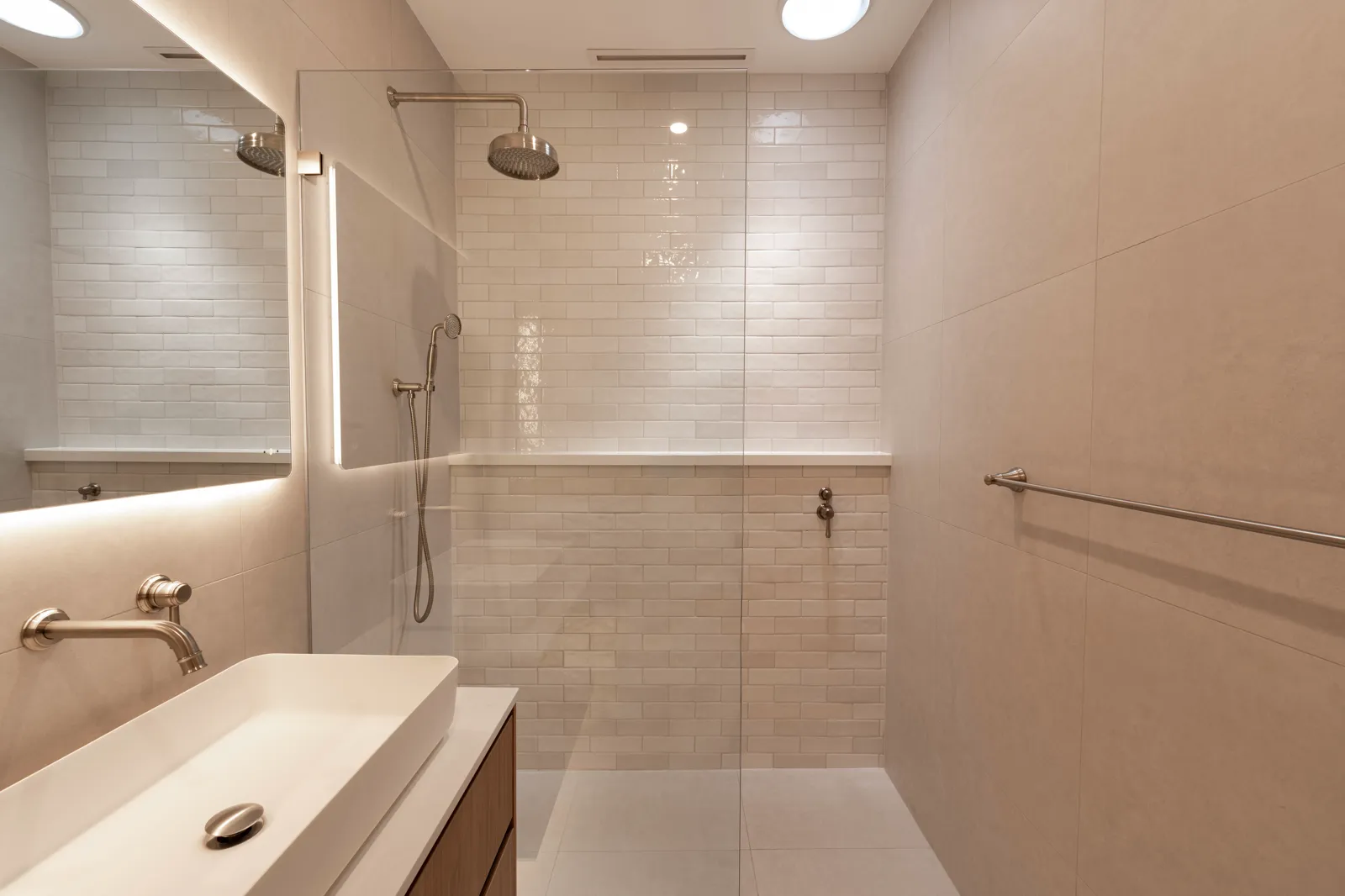 Ensuite with walk-in frameless glass shower, subway tiles and brushed nickel tapware
