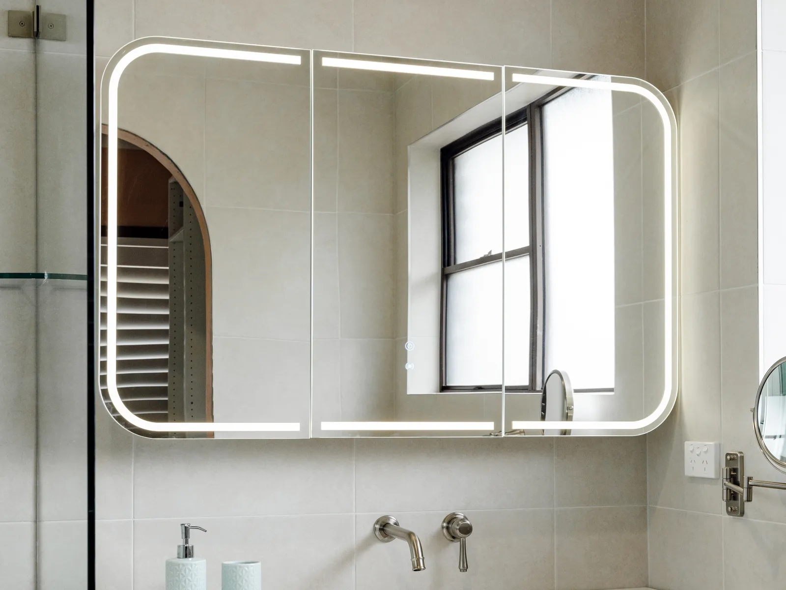 New ensuite with timber vanity, LED backlit mirror cabinet, and floor-to-ceiling stone-look tiles