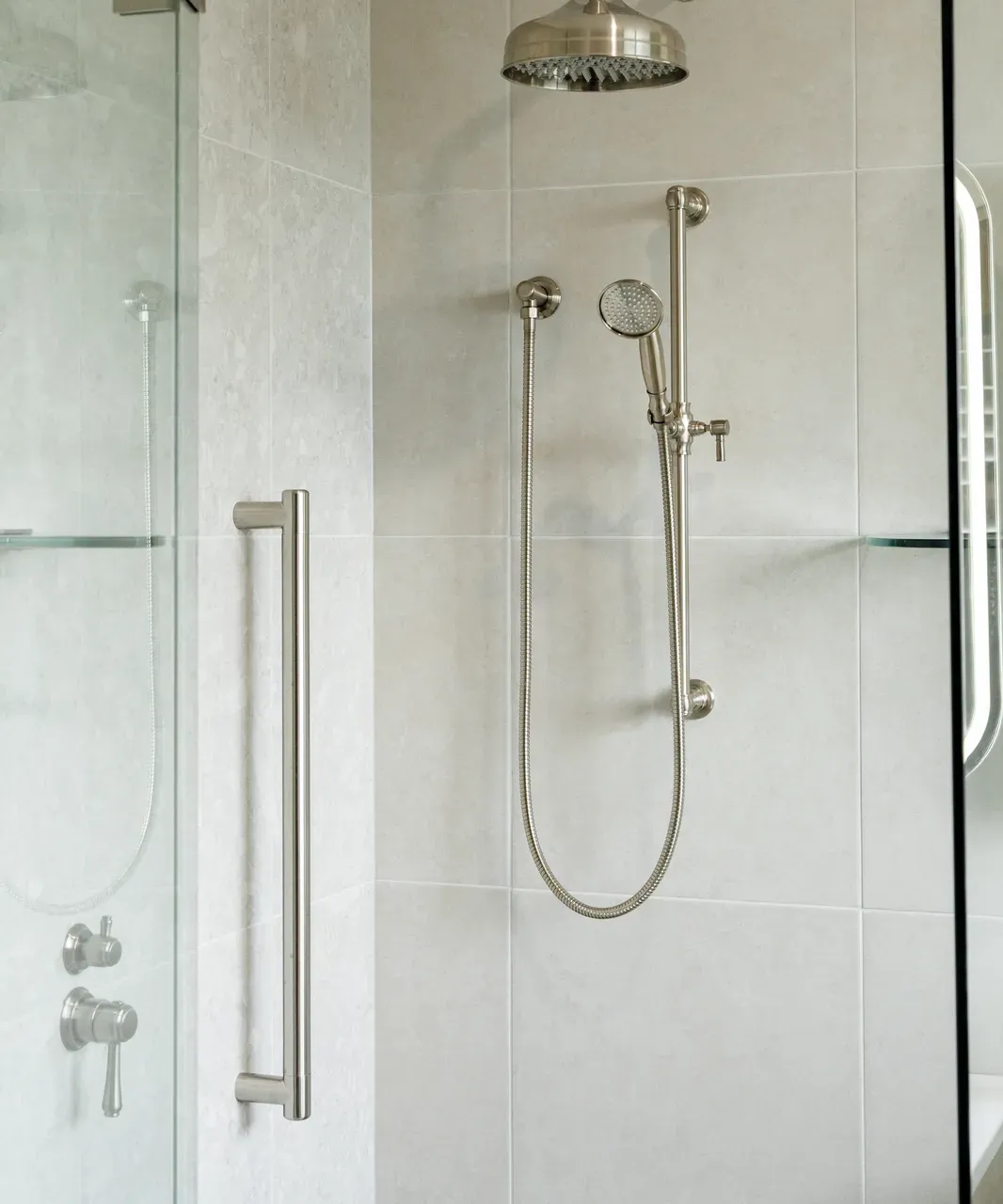 Ensuite shower with Kingsley brushed nickel rainfall head, hand shower on rail, and frameless glass screen