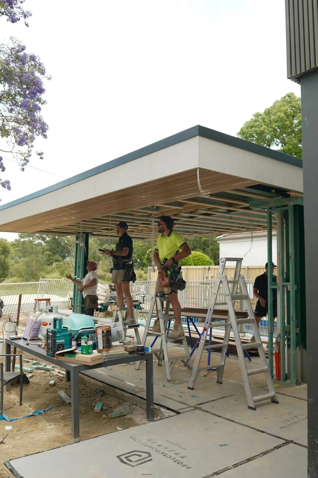 The LikeSilk team installing the spotted gum ceiling lining beneath the cabana roof