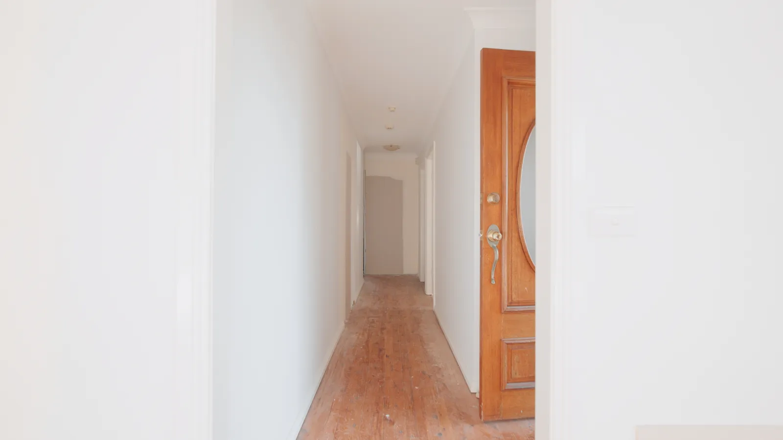 Toongabbie hallway before renovation with bare original floorboards