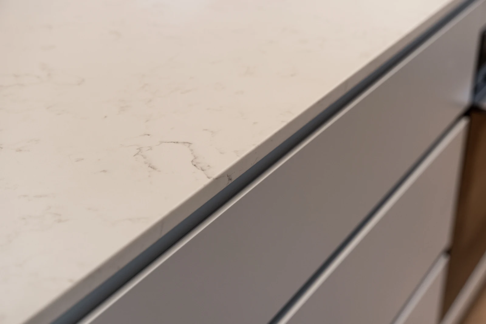Close-up of the baby blue kitchen cabinetry against the Caesarstone benchtop edge
