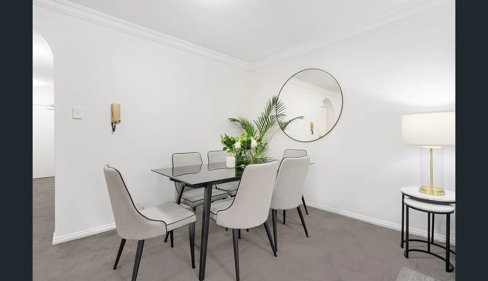 The dining area at the Wollstonecraft apartment before renovation, with carpet throughout