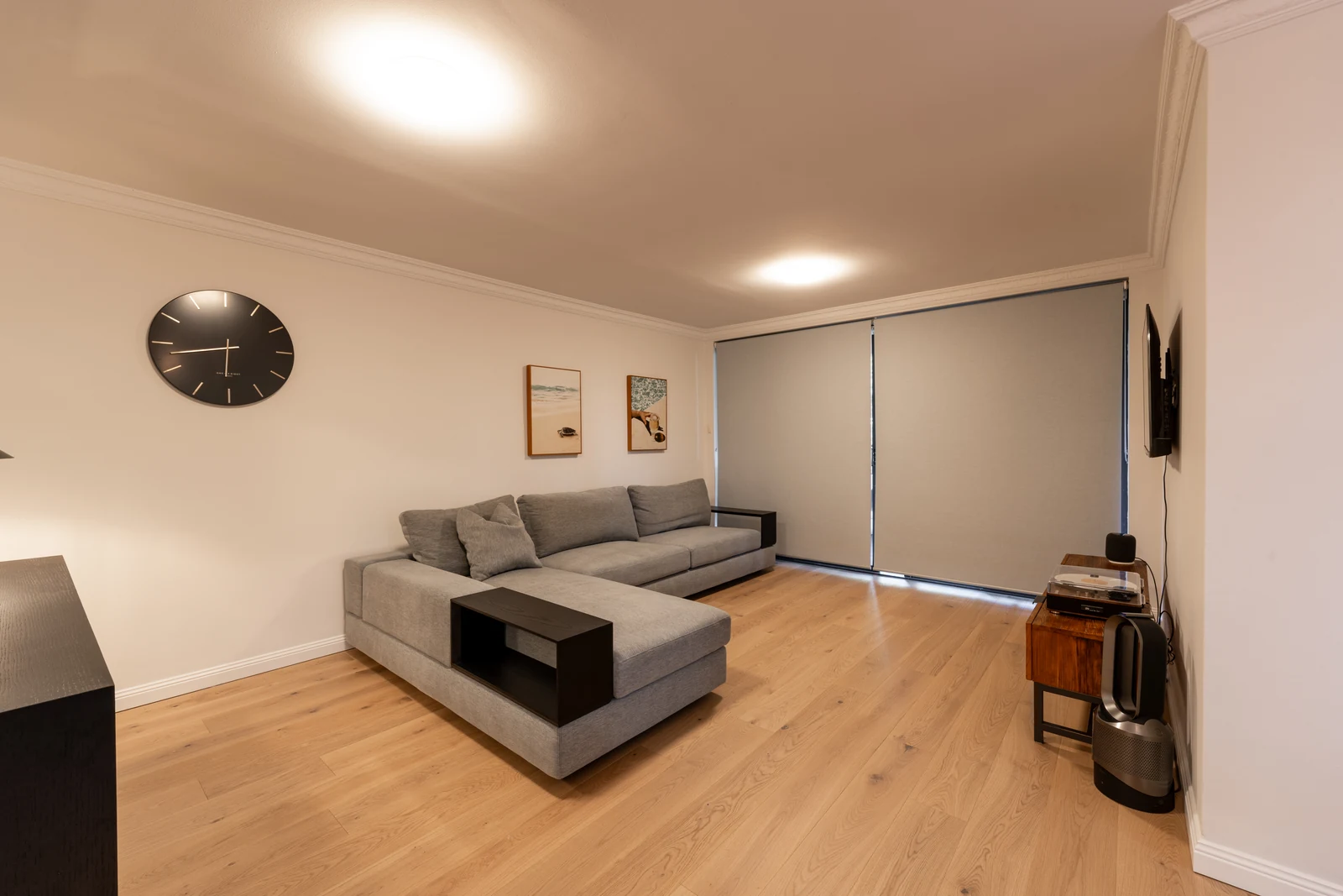Living area of a renovated Wollstonecraft apartment with engineered oak flooring replacing the original carpet
