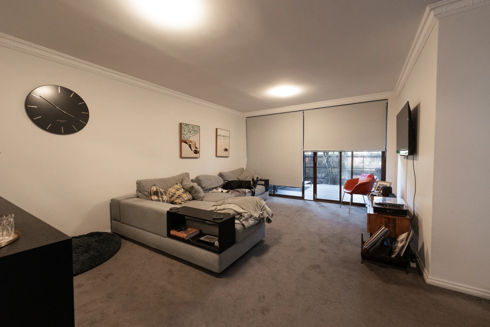 The living area before renovation, with worn carpet throughout
